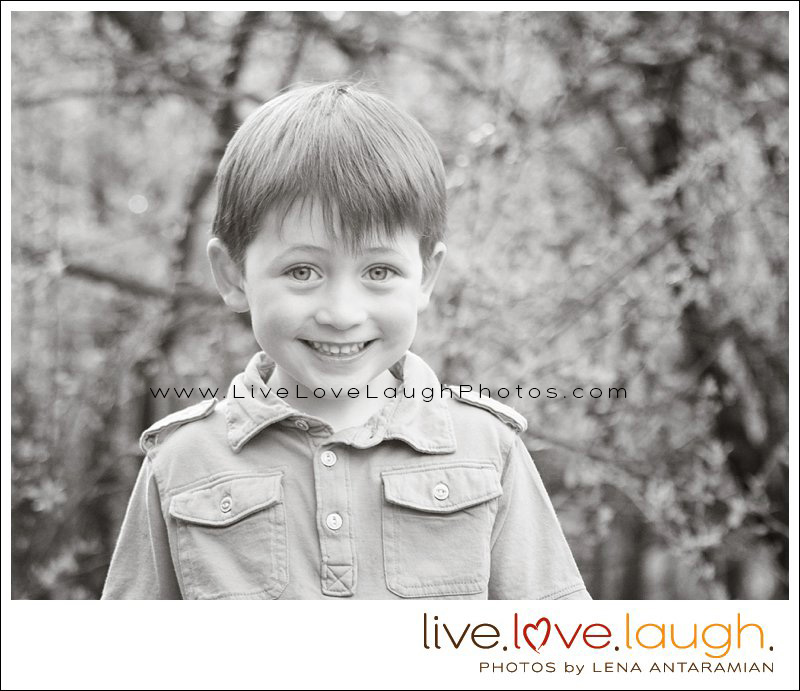 A close up of a cute little boy with a huge grin