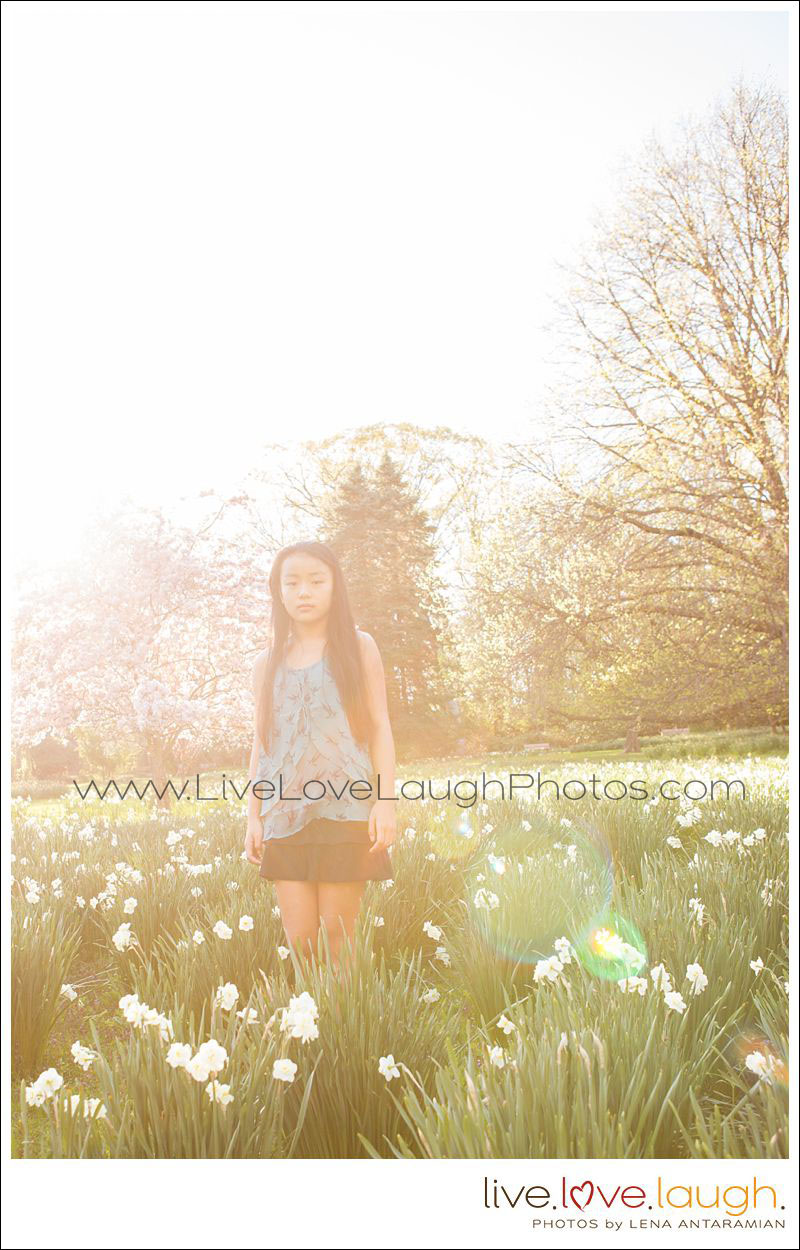 Tween girl standing in a field of flowers at a professional photo session
