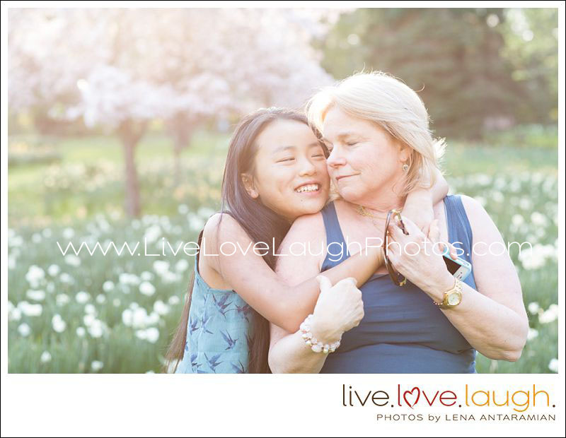 Mother and daughter hugging in a field of flowers at their photo session