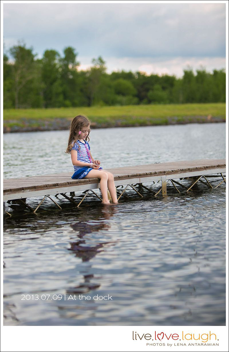 A girl sitting on a dock